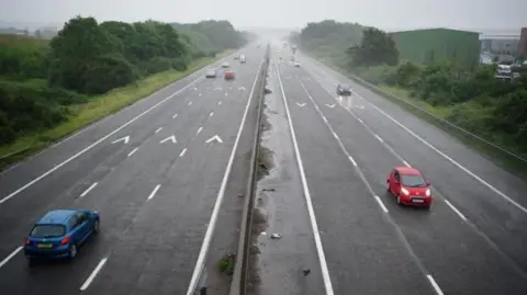 LDRS An overhead shot of two motorway lanes on the M4 with several cars driving on the carriageways.