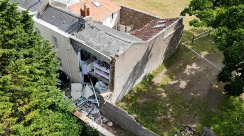 BBC Aerial view of a house damaged in an incident in Jersey