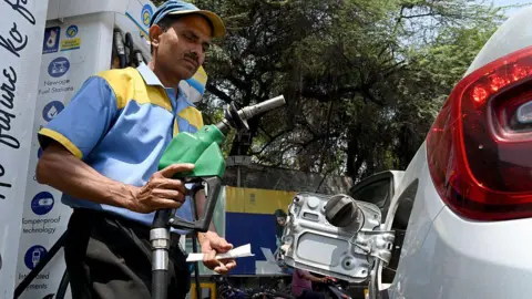 A petrol pump attendant fills fuel in a vehicle at a petrol station, on 16 May, 2026 in New Delhi, India.