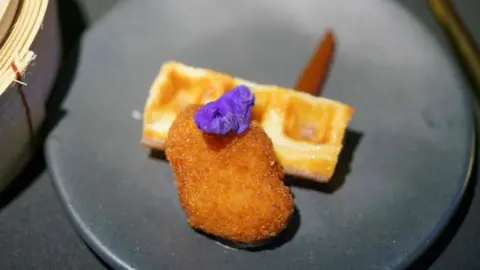 NICHOLAS YEO/AFP A nugget made from lab-grown chicken meat is seen during a media presentation in Singapore, the first country to allow the sale of meat created without slaughtering any animals, on December 22, 2020