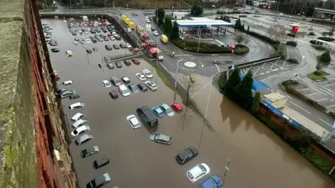 Flooding at Meadow Mill in Stockport, with submerged cars seen from the top floor of the apartment complex.