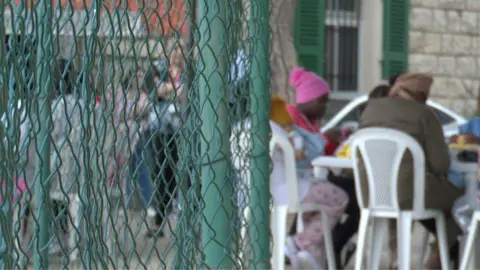 Women sitting with their back to the camera in Lebanon
