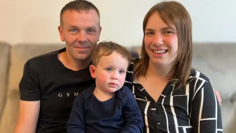 BBC Leo in between his two parents Daniel and Sarah Statham