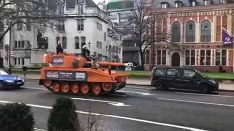 Martin Heath/BBC Orange tank driving past buildings in Parliament Square