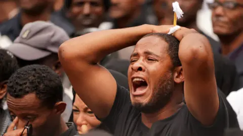 Getty Images A mourner screams for a loved one who perished in the Ethiopian Airways ET302 during a memorial service at Selassie Church on March 17, 2019 in Addis Ababa, Ethiopia.