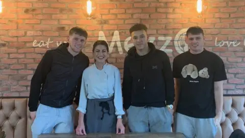 Meezo Co-owner Skevy Ioannides with three Derby County players