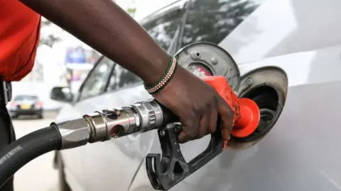 A man fills a car with petrol