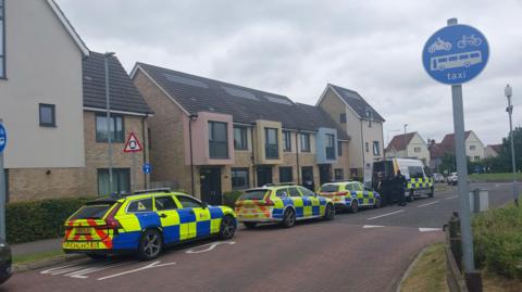 Police cars parked near the property in Colchester