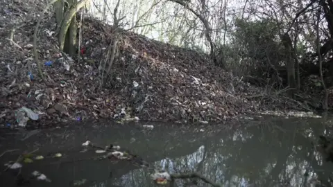 The rubbish heap next to a the river 