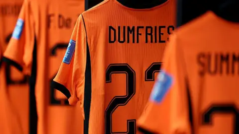 Getty Images A set of Dutch bright orange football strips one with the name Dumfries clearly visible on its back