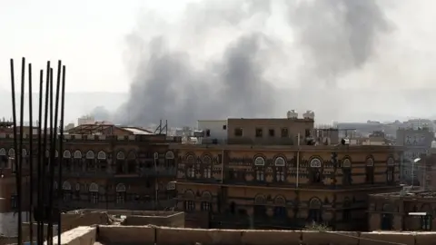 EPA Smoke billows above a neighbourhood following Saudi-led airstrikes targeting positions in Sana"a, Yemen