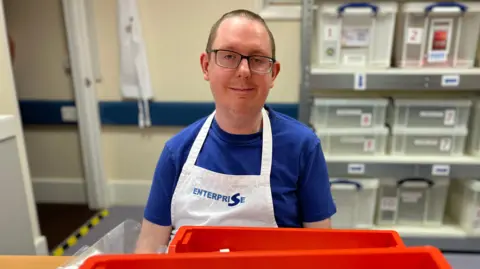 Marti from Enterprise Packaging wearing a white apron used for packaging transplant retrieval kits