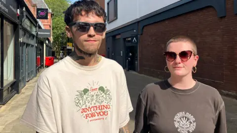 Shariqua Ahmed/BBC Jason Rivers and Katie smiling for camera 