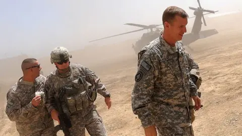 Getty Images Commander of the NATO-led International Security Assistance Force (ISAF) US General Stanley McChrystal (R) arrives at the Baraki Barak Joint combat Outpost (JCOP) in Logar Province on 21 August 2009