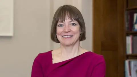 Professor Shearer West wearing a deep pink dress