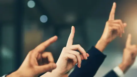 Getty Images People with their hands up
