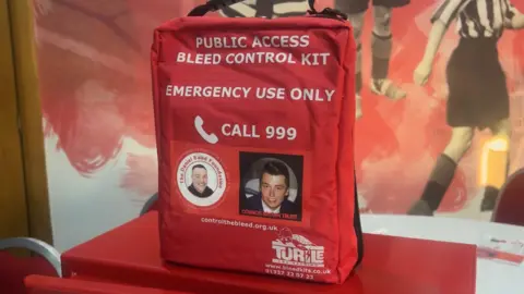 Bleed kits containing bandages which stop catastrophic bleeding on display at the Stadium of Light. The bag also features a picture of Connor Brown who was murdered in 2019 in Sunderland. 