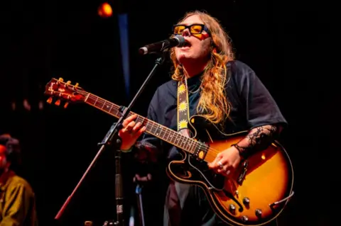 Garryjonesphotography Woman on stage with a guitar