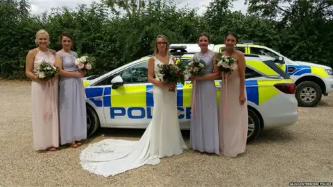 Gloucestershire Police Bridal party posing by police cars