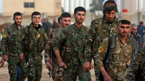 AFP Members of the Kurdish People's Protection Units (YPG) attend a funeral in Qamishli (3 March 2018)