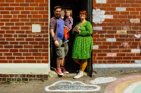 Ellie Grace Photography Doorstep portrait of Chris, Charlie and Lyra in Heeley