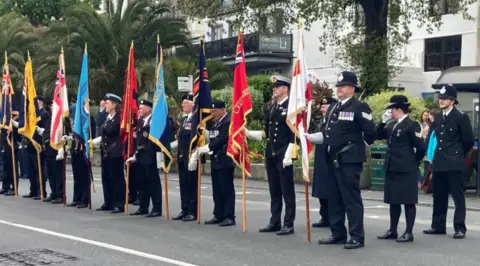 Group stand in a line from previous parade