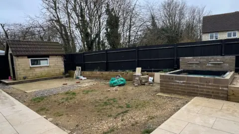 Mr and Mrs Hall's garden in an unfinished state with stone everywhere