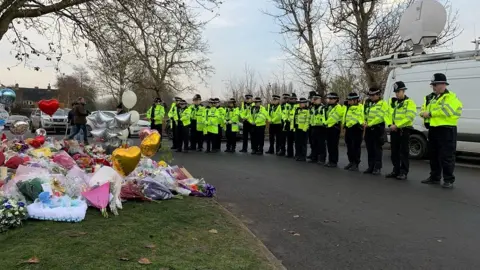 PA Media Police lay flowers