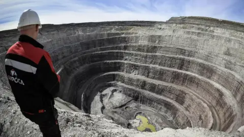 Alrosa A worker stands over an openpit mine