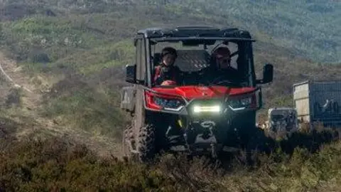 GMFRS Firefighters in a buggy on the moors