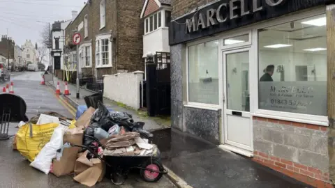 Simon Jones/BBC Sewer repairs outside Marcello Marino's home in Ramsgate