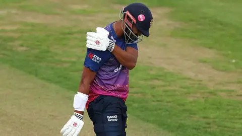 Emilio Gay clutching his right shoulder during Durham's match with Middlesex