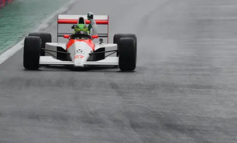 Carla Carniel/Reuters Mercedes' Lewis Hamilton waves the Brazilian emblem  arsenic  helium  drives the McLaren MP4/5B of erstwhile  satellite   champion   operator  Ayrton Senna 