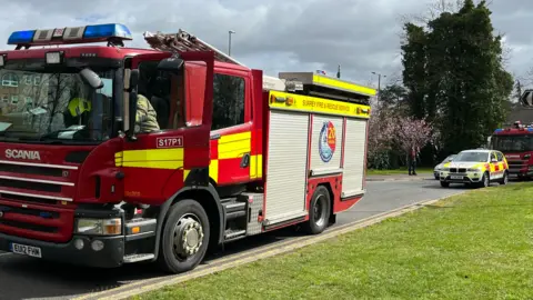 A fire engine on a lawn.