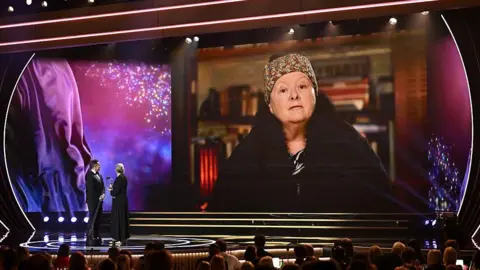 Getty Images Magda Szubanski seen accepting an award on screen