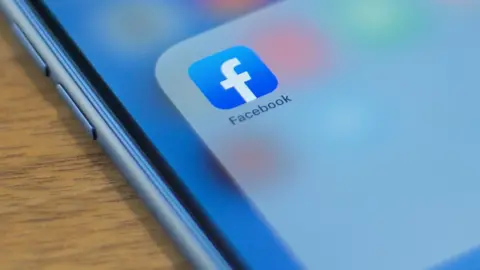 AFP/GETTY IMAGES In this file photo taken on July 10, 2019 the Facebook logo is seen on a phone in this photo illustration in Washington.