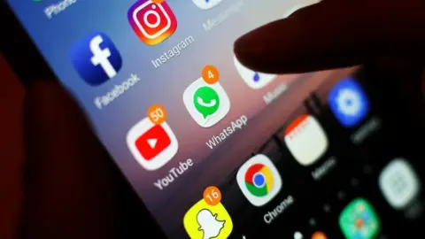 PA Media A stock photo shows social media apps on the home screen of a smartphone