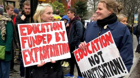 BBC People outside the University of Glasgow after members of the University and College Union begin an eight-day strike in rows over pay, conditions and pensions in 2019