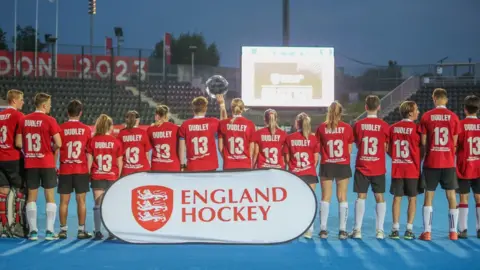 University of Bristol/SmifSports Photograp Hockey players wearing red and black kit with the name 'Dudley' and number '13' printed on the backs