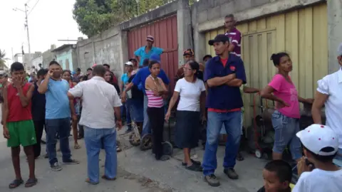 People waiting in line for cooking gas