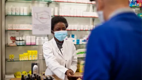 Getty Images File picture of pharmacist and patient