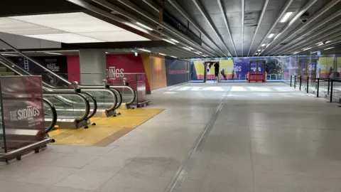 Empty shops by escalator