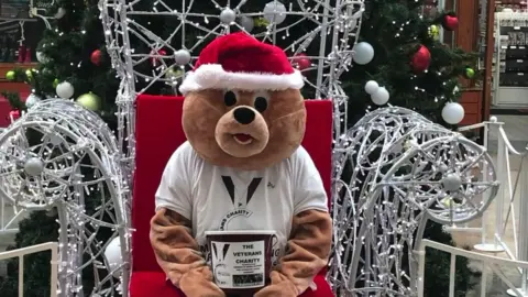 Danny Greeno Bear sat on Christmas throne in Veterans Charity t-shirt