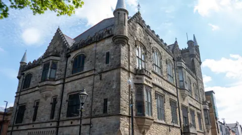 The Apprentice Boys of Derry Memorial Hall, Society Street is a historic brown and grey Neo-gothic building located on Society Street.