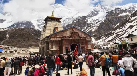 Getty Images Pilgrims mill around the outside of the Kedarnath Temple