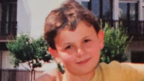 Dalibor Sentic Childhood photo of Dalibor Sentic aged 10. He has short brown hair and is wearing a yellow t-shirt.