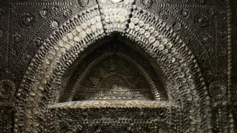 Jadzia Samuel/BBC A mural that was created with shells.