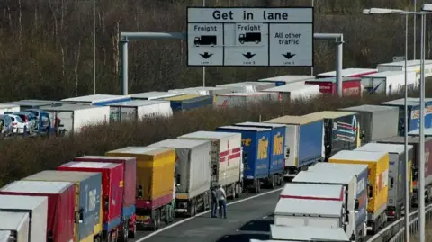 Lorries queueing in four lanes of a motorway
