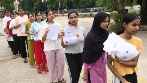 Hindustan Times via Getty Images Aspirants standing in queue before appearing in the National Eligibility cum Entrance Test (NEET) UG 2026 exam conducted by National Testing Agency (NTA) at an examination centre, B.S. College, Danapur on May 3, 2026 in Patna, India