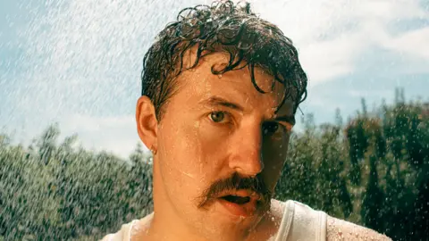 Marieke Macklon A picture of Kai. He has black hair and short moustache. 